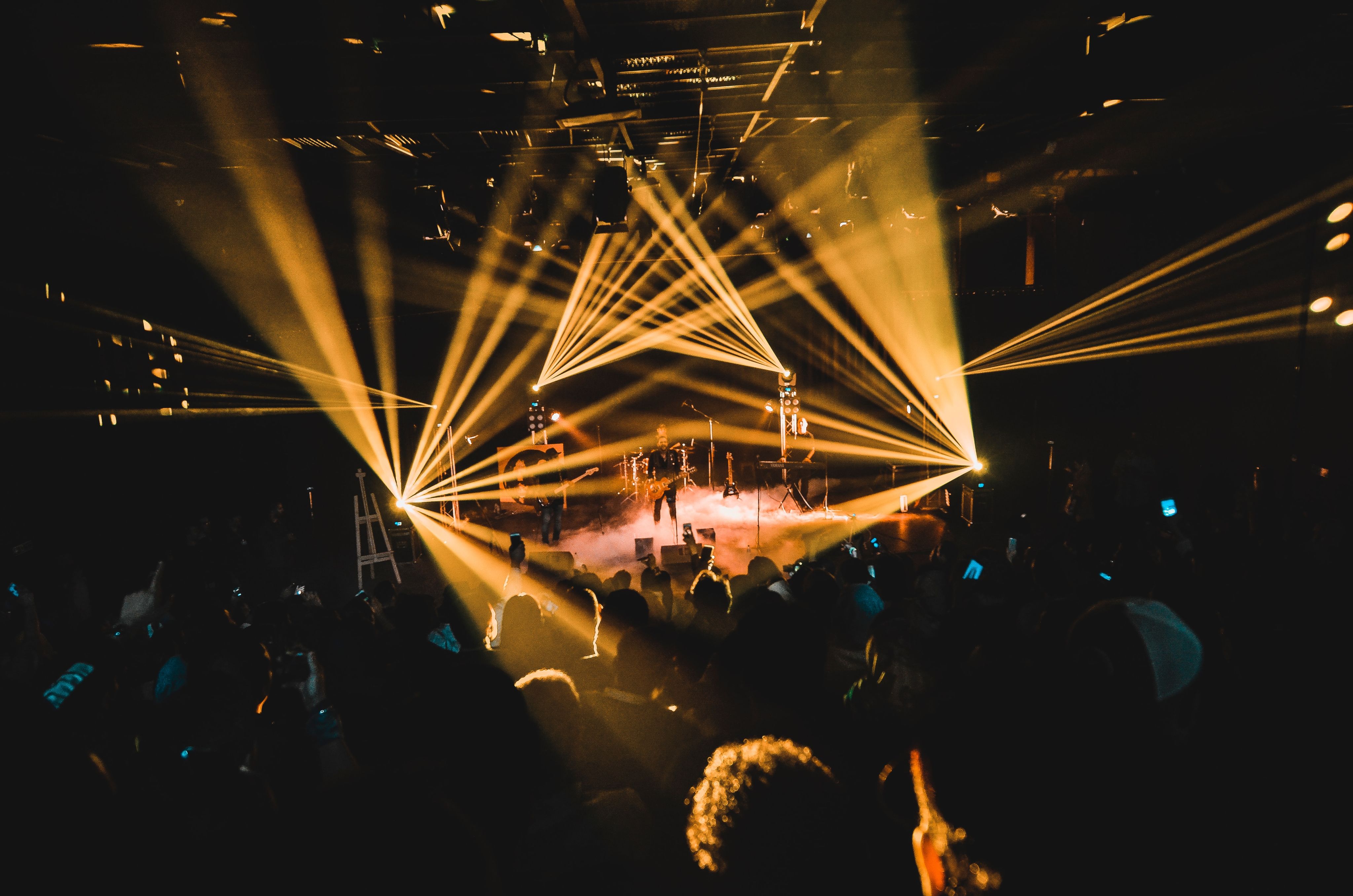 people standing on stage with lights