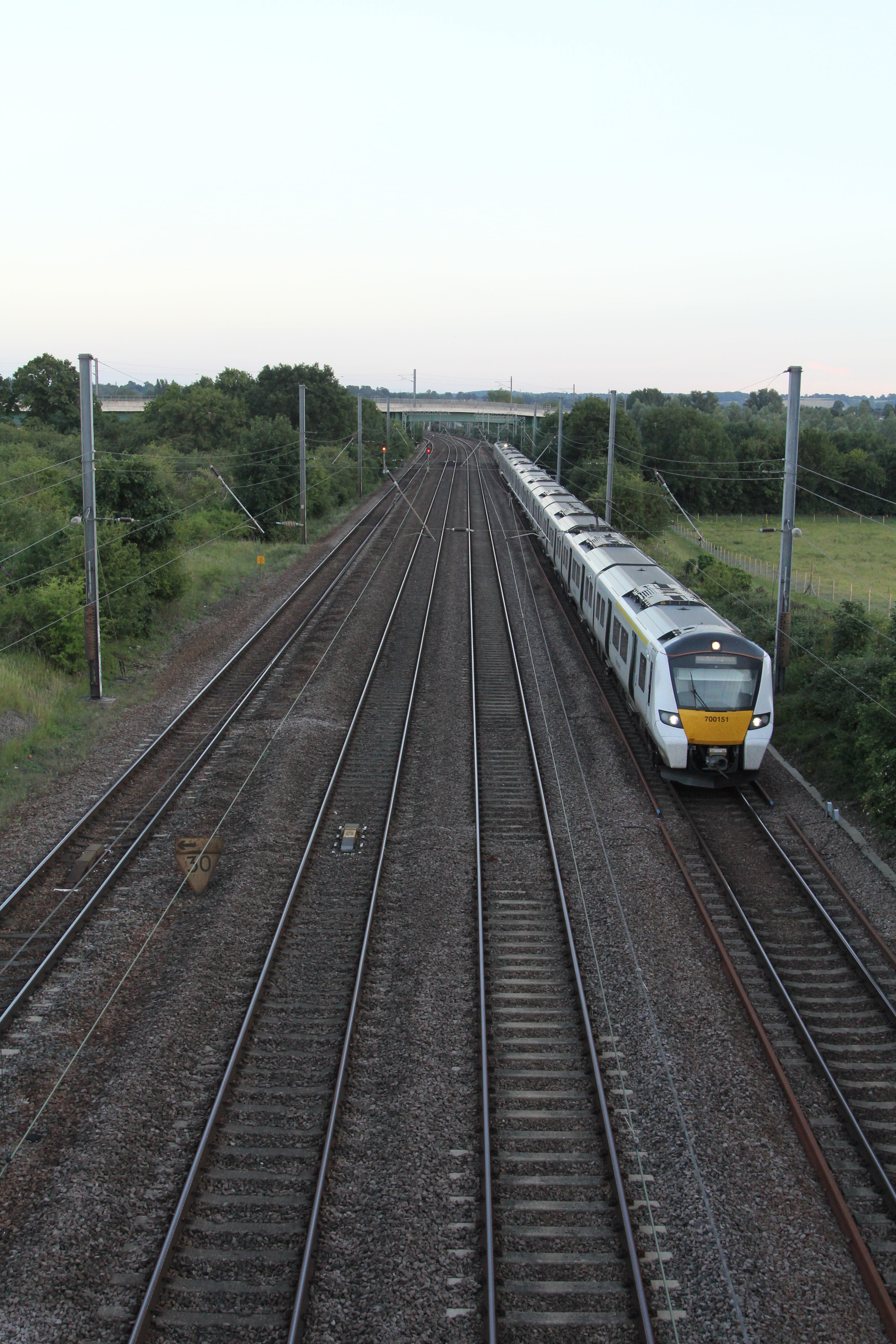 white and yellow train on rail tracks during daytime