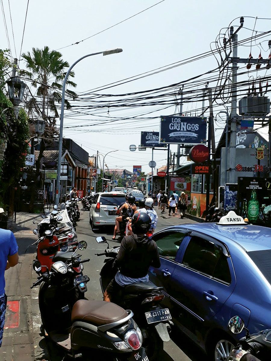 A traffic-choked street in Seminyak, a main tourist zone on Bali, which straddles the line between mass tourism and preserving cultural traditions.