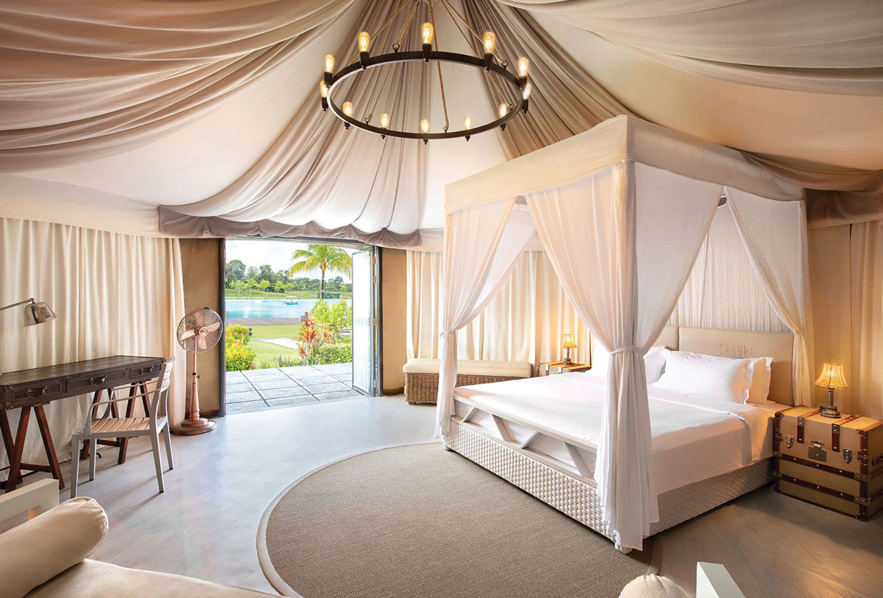 A Natra Bintan accommodation featuring amenities like a garden and outdoor patio, four-poster bed, LCD TV, air conditioning and WiFi.
