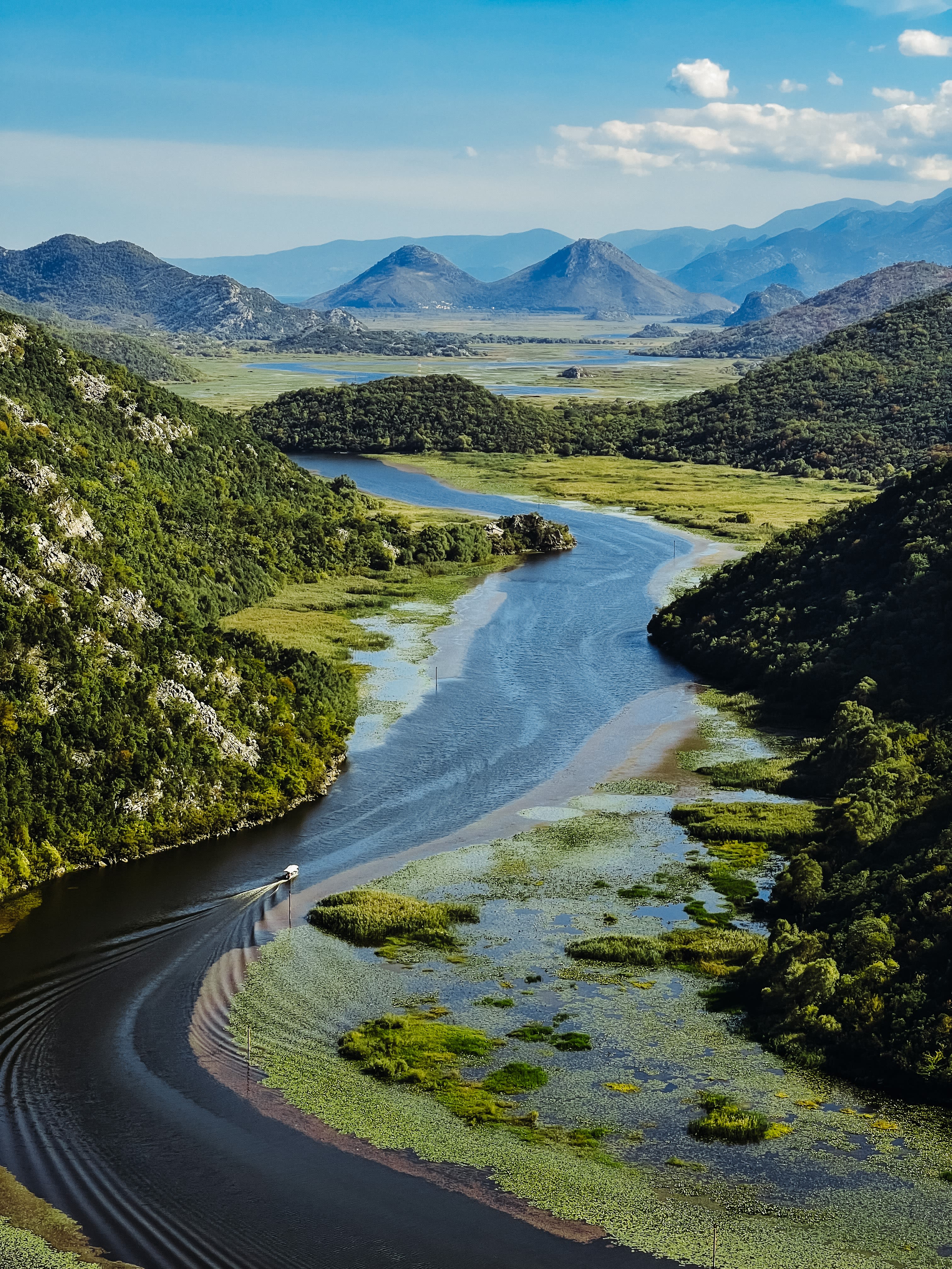 a river running through a lush green valley